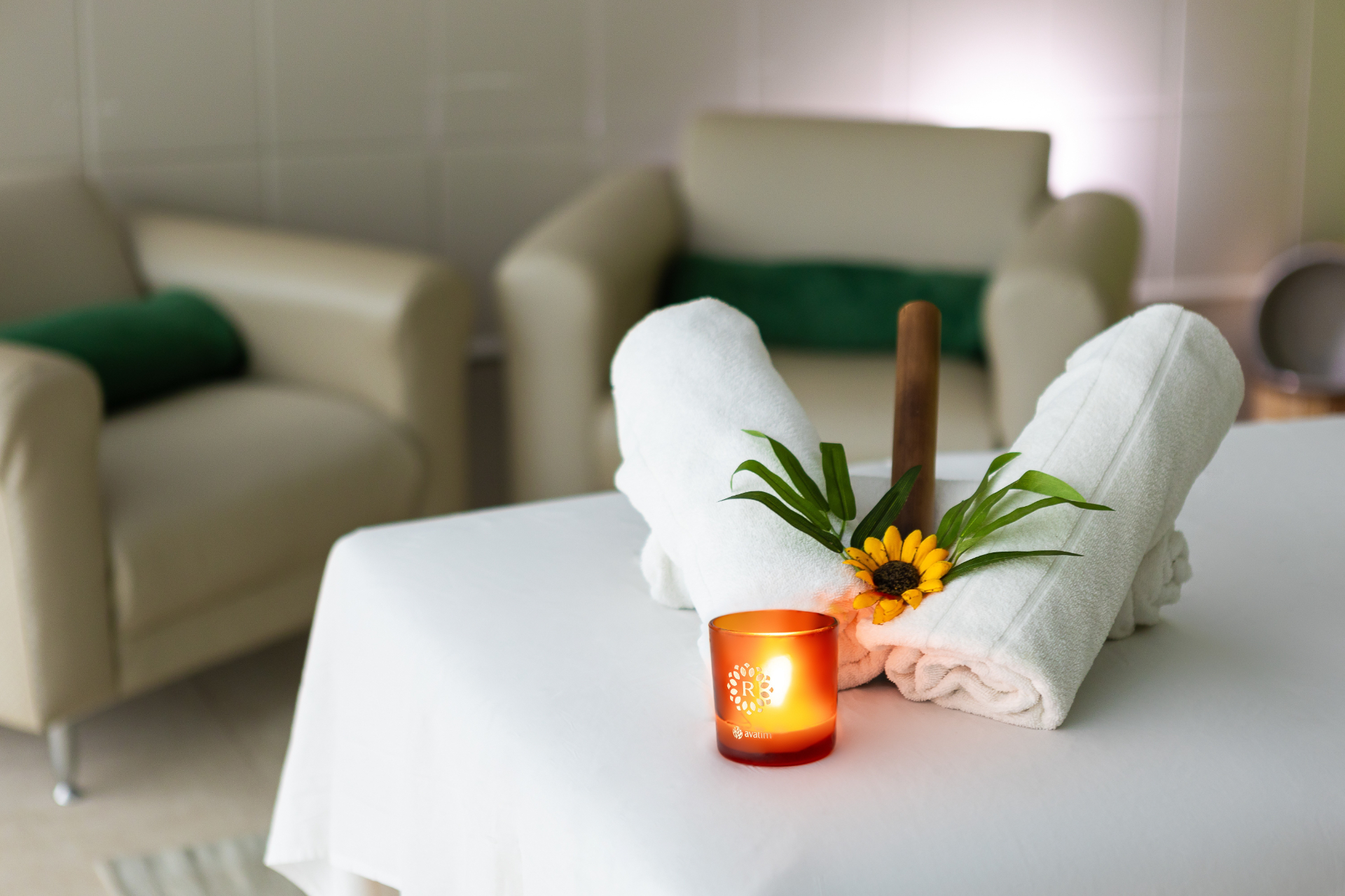 Ambiente de relaxamento com toalhas e vela no Thermas Resort
